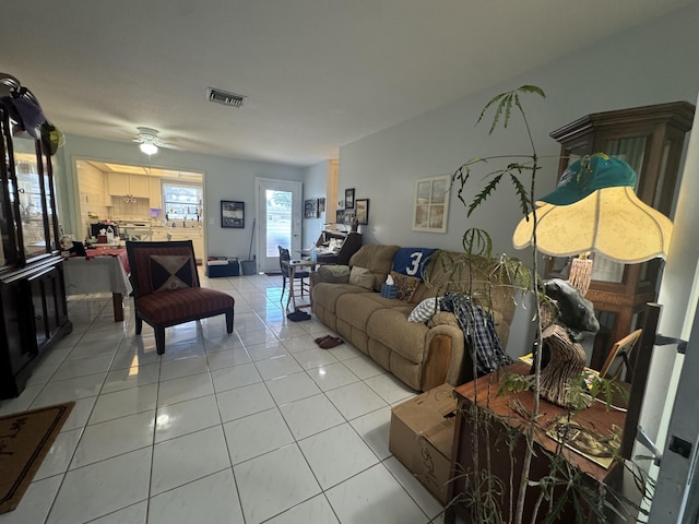 living room with visible vents, a ceiling fan, and light tile patterned floors