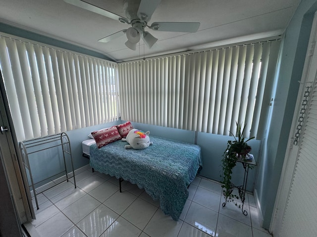 bedroom with ceiling fan and light tile patterned flooring