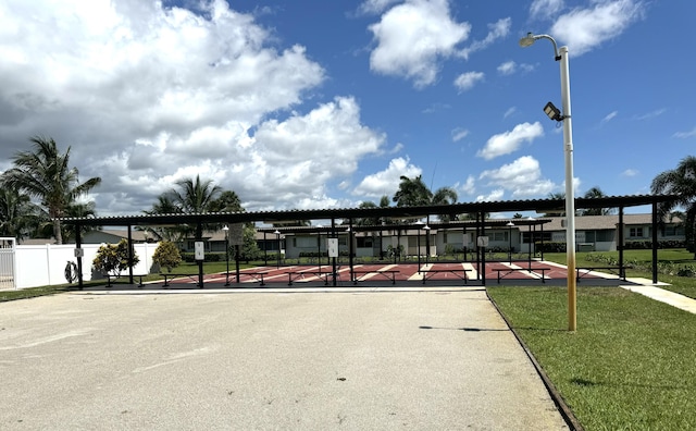 view of community featuring fence and a yard