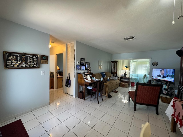 living room featuring lofted ceiling and light tile patterned floors