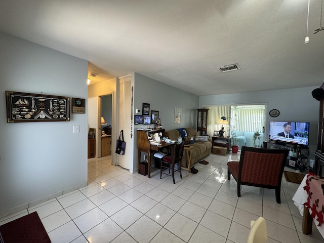 living room featuring visible vents and light tile patterned floors