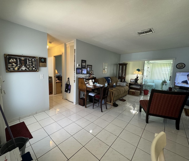 living area featuring visible vents and light tile patterned floors