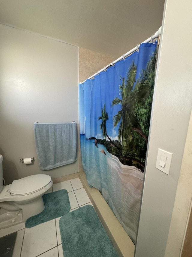 bathroom featuring tile patterned floors, a shower with shower curtain, and toilet
