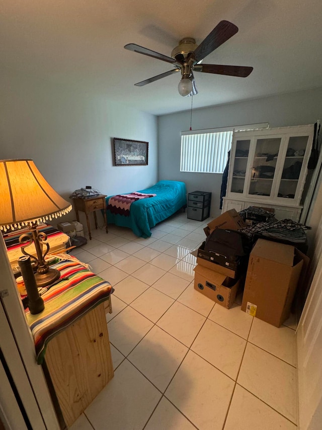 bedroom with ceiling fan and light tile patterned floors