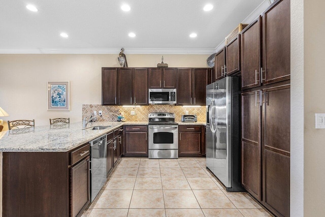 kitchen with sink, tasteful backsplash, kitchen peninsula, crown molding, and appliances with stainless steel finishes