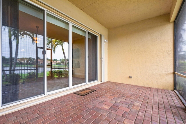 unfurnished sunroom featuring a water view