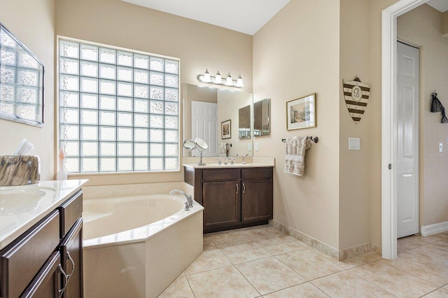 bathroom featuring a washtub, vanity, and tile patterned floors