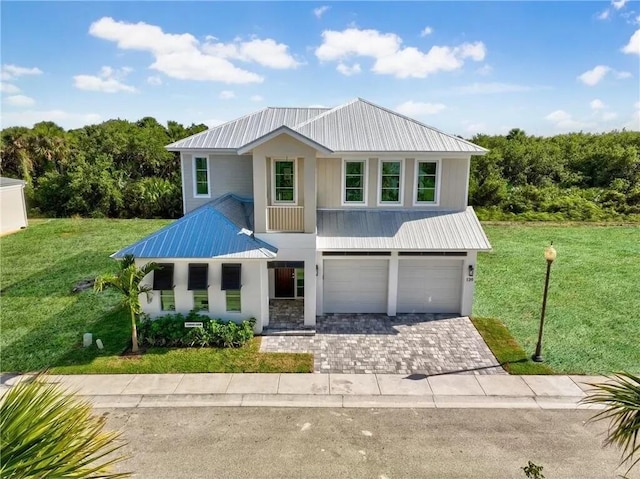 view of front of property featuring a front yard and a garage