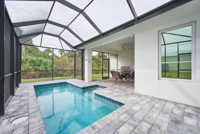 view of swimming pool with a patio area, a lanai, and ceiling fan