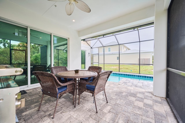 sunroom / solarium with a pool and ceiling fan