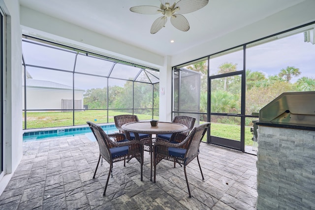 sunroom with a pool and ceiling fan