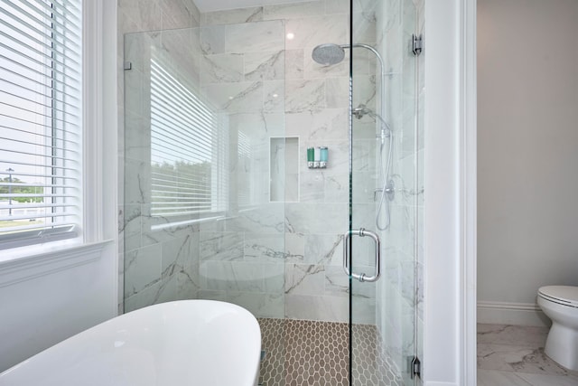 bathroom with a shower with shower door and toilet