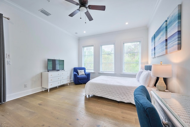 bedroom with light hardwood / wood-style flooring, crown molding, and ceiling fan