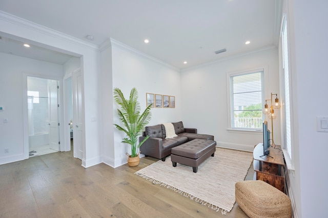 living room with crown molding and light wood-type flooring