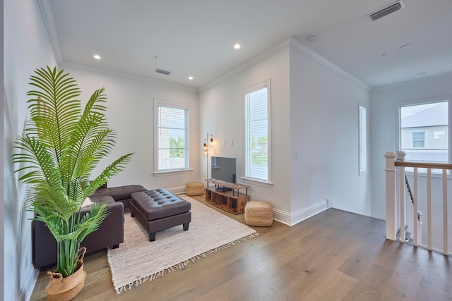 living area with ornamental molding and wood-type flooring