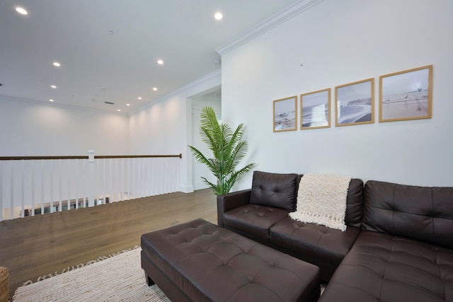 living room with crown molding and hardwood / wood-style floors