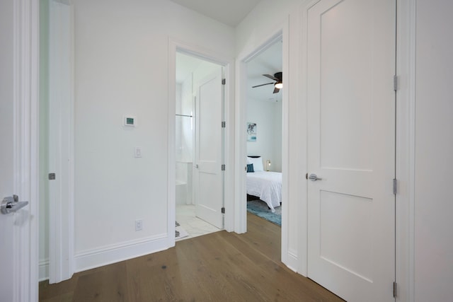 corridor with hardwood / wood-style floors