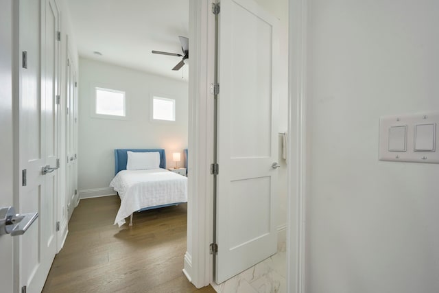 bedroom with light hardwood / wood-style floors and ceiling fan