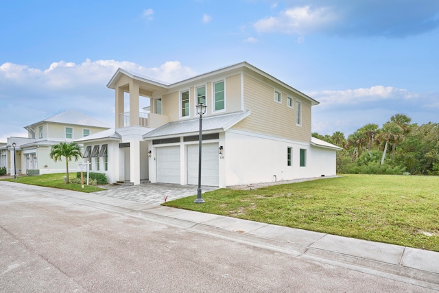 view of front of house with a balcony, a front lawn, and a garage