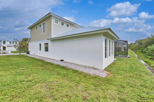 view of home's exterior with central AC unit and a lawn