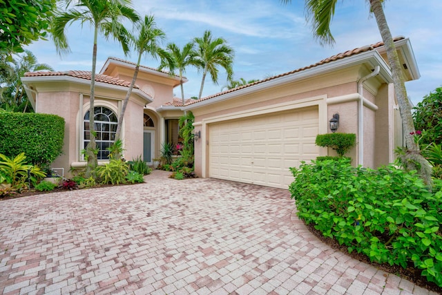 mediterranean / spanish-style house featuring a garage