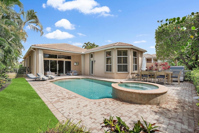 view of pool featuring an in ground hot tub, a patio, a grill, and ceiling fan