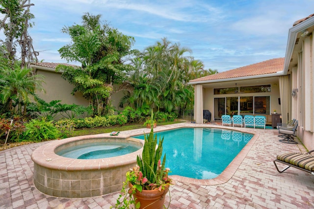 view of pool with an in ground hot tub and a patio