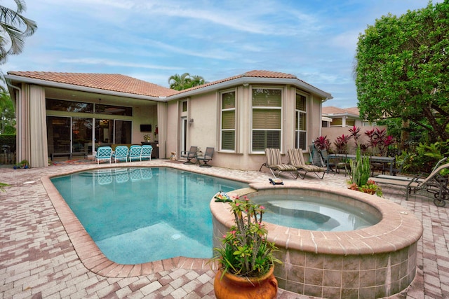 view of pool featuring an in ground hot tub, a patio area, and ceiling fan