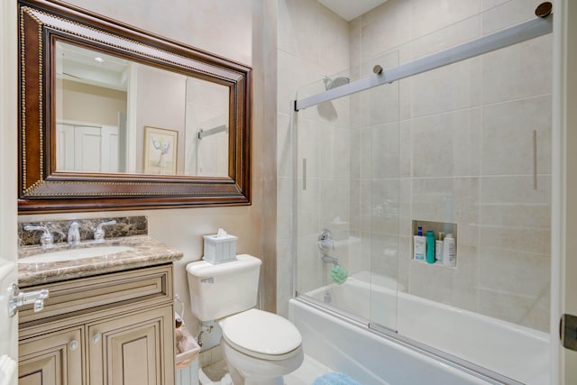 full bathroom featuring shower / bath combination with glass door, vanity, and toilet