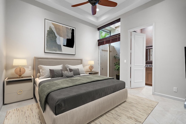 tiled bedroom with ensuite bathroom and ceiling fan