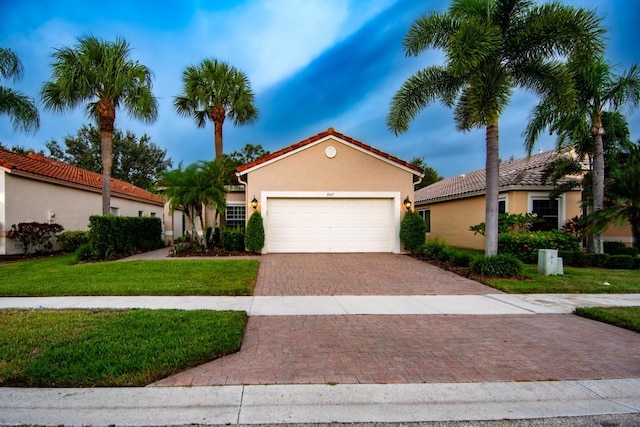 mediterranean / spanish-style house with a front lawn and a garage