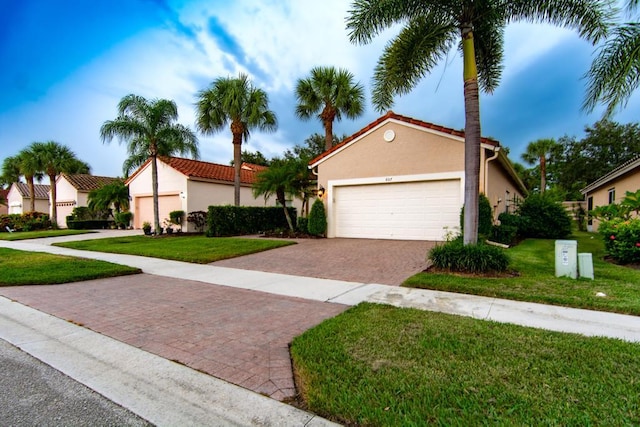 view of front of property featuring a garage and a front yard