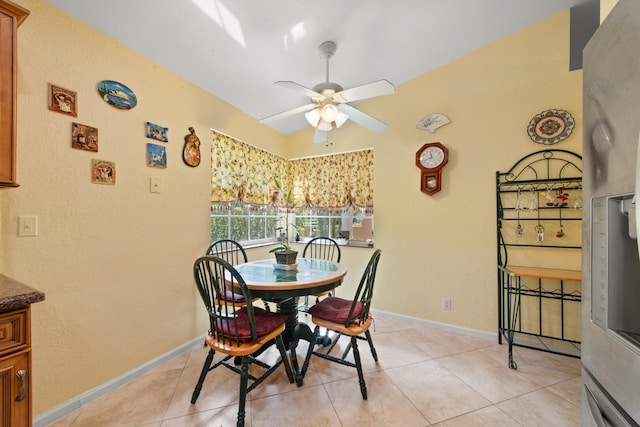 tiled dining area featuring ceiling fan