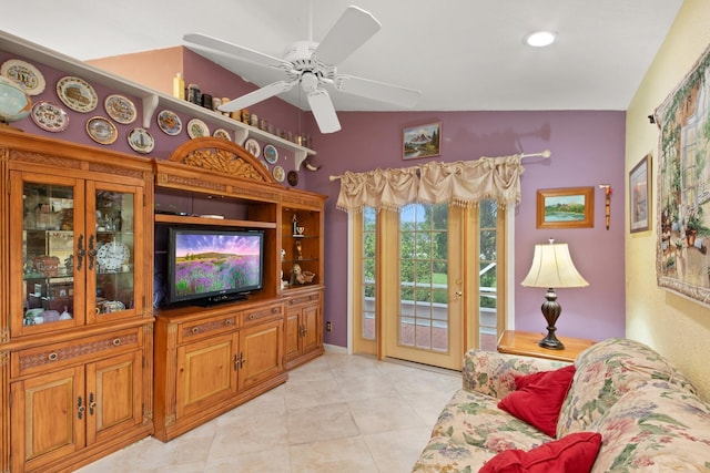 living room with ceiling fan, light tile patterned flooring, and vaulted ceiling