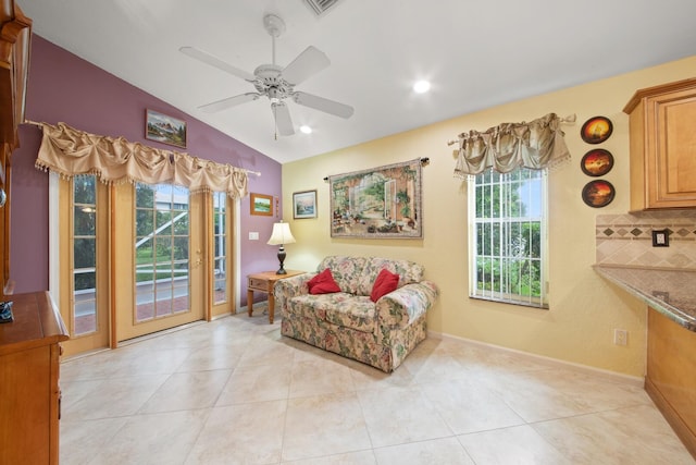 sitting room featuring lofted ceiling, light tile patterned flooring, and ceiling fan