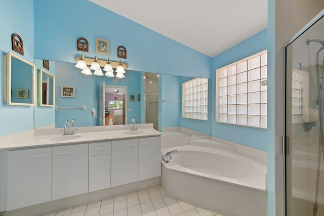 bathroom with a healthy amount of sunlight, separate shower and tub, and vaulted ceiling