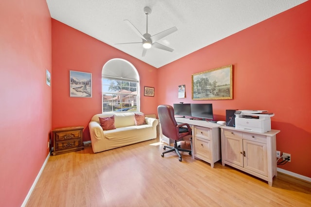 home office featuring light hardwood / wood-style floors, a textured ceiling, lofted ceiling, and ceiling fan