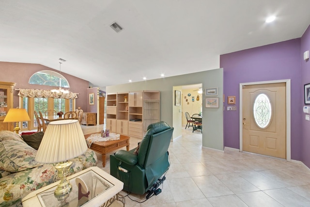 living room with a chandelier, light tile patterned floors, and vaulted ceiling