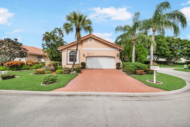 view of front of house with a front yard and a garage