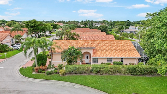 view of front of property with a front yard and a lanai