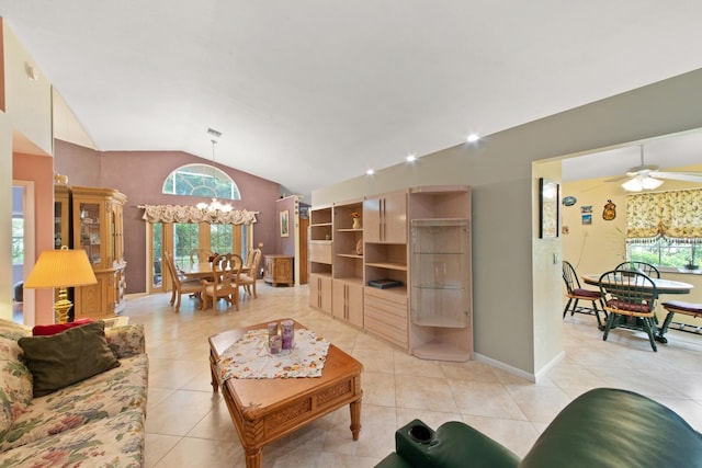 tiled living room featuring vaulted ceiling and ceiling fan with notable chandelier