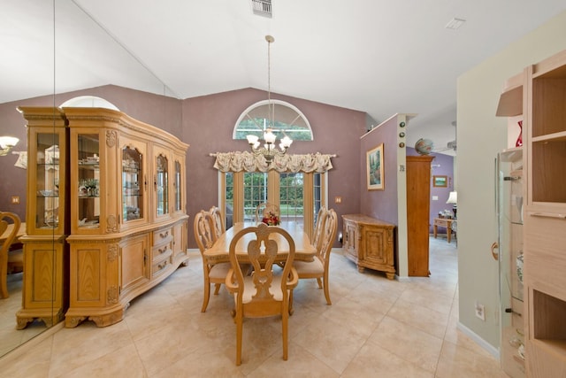 tiled dining area with lofted ceiling and ceiling fan with notable chandelier