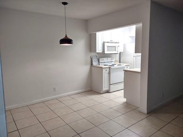 kitchen featuring white cabinets, light tile patterned flooring, decorative light fixtures, and white appliances