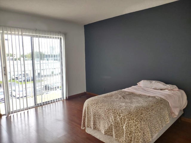 bedroom with hardwood / wood-style flooring and access to outside