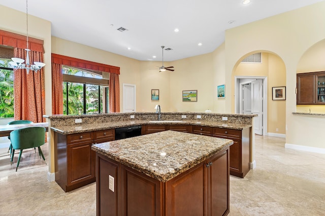 kitchen with a center island, pendant lighting, ceiling fan with notable chandelier, and black dishwasher