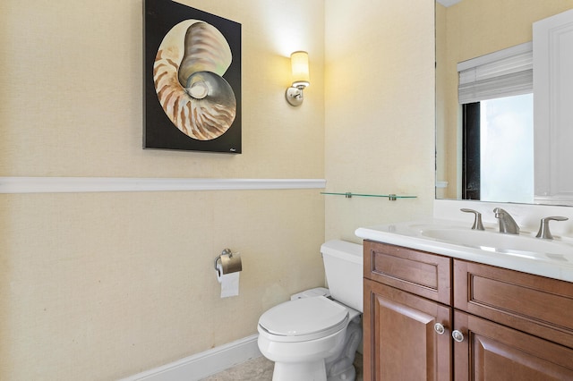 bathroom featuring vanity and toilet