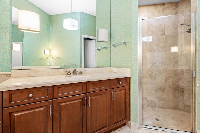 bathroom featuring vanity and a shower with door