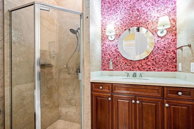 bathroom featuring vanity and a shower with door