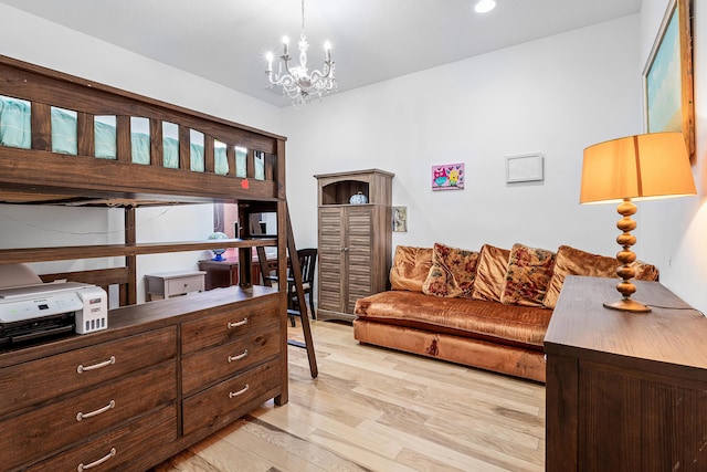 bedroom featuring a chandelier and light hardwood / wood-style flooring