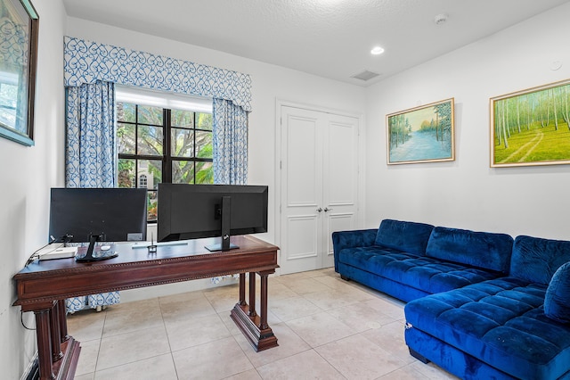 office featuring light tile patterned floors and a textured ceiling